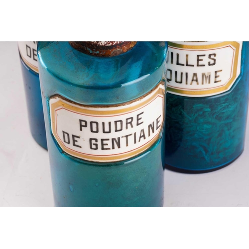 377 - Thirteen French blue glass apothecary jars, with white porcelain labels and tin lids, tallest 25 cm ... 