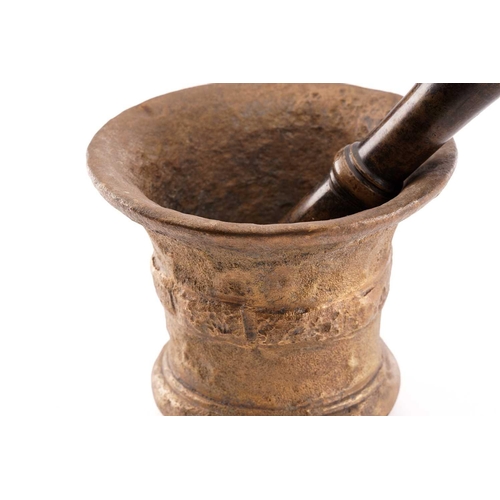 380 - A bronze pestle and mortar, the mortar with collared tapering sides, 15 cm high 17.5 cm diameter, th... 