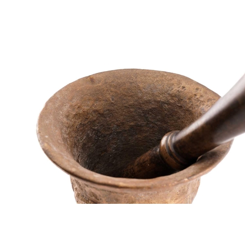 380 - A bronze pestle and mortar, the mortar with collared tapering sides, 15 cm high 17.5 cm diameter, th... 