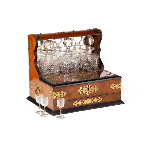 395 - A Victorian walnut and gilt-metal mounted three decanter tantalus and games compendium, the square d... 