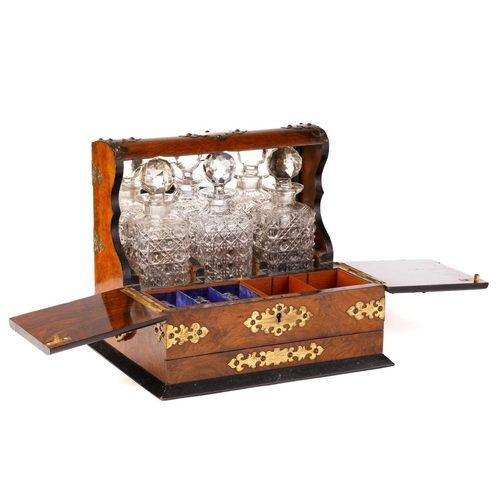 395 - A Victorian walnut and gilt-metal mounted three decanter tantalus and games compendium, the square d... 