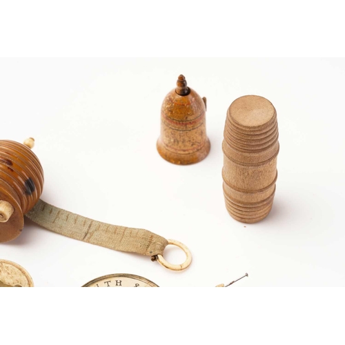 398 - A 19th century sewing tape measure in the form of a beehive, with bone fittings, 5 cm high, together... 