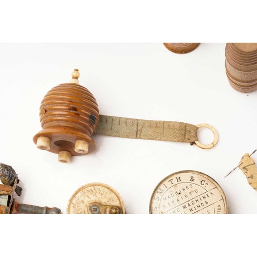 398 - A 19th century sewing tape measure in the form of a beehive, with bone fittings, 5 cm high, together... 