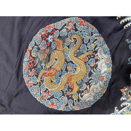 379 - A Chinese cobalt blue silk courtiers waistcoat(?) with six bullion embroidered Imperial dragon round... 