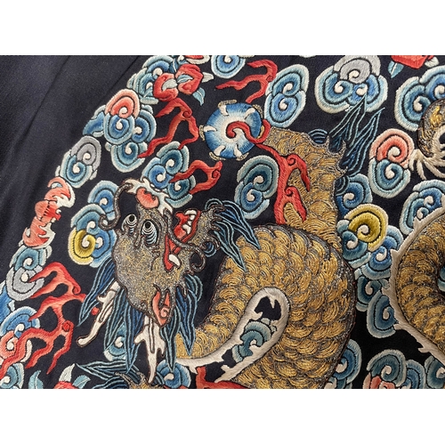 379 - A Chinese cobalt blue silk courtiers waistcoat(?) with six bullion embroidered Imperial dragon round... 