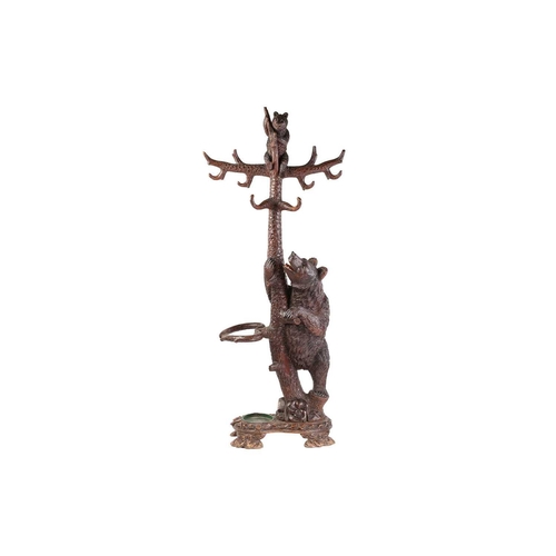 1 - A large late 19th-century carved wood Black Forest Bear hall stand; modelled as a bear cub seated at... 