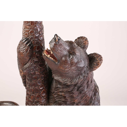 1 - A large late 19th-century carved wood Black Forest Bear hall stand; modelled as a bear cub seated at... 
