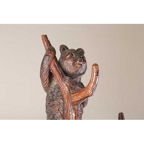 1 - A large late 19th-century carved wood Black Forest Bear hall stand; modelled as a bear cub seated at... 