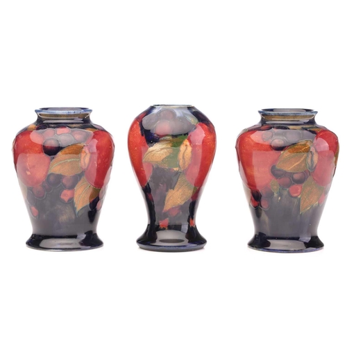 A pair of Moorcroft 'Pomegranate' small vases, circa 1920, impressed