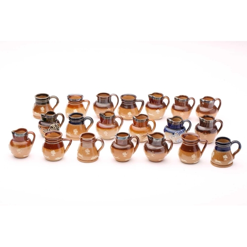 58 - Twenty Doulton stoneware miniature harvest jugs, twelve of them having silver rims, largest 4.5cm hi... 