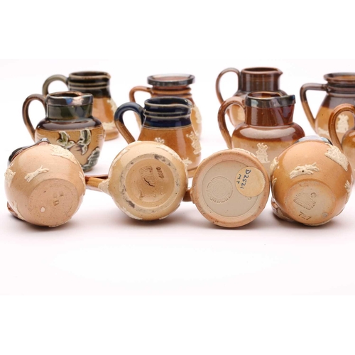 58 - Twenty Doulton stoneware miniature harvest jugs, twelve of them having silver rims, largest 4.5cm hi... 