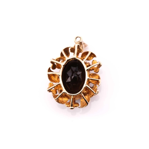 10 - A single stone smokey quartz pendant; the oval cut stone in foliate mount to plain bale, marked '9ct... 