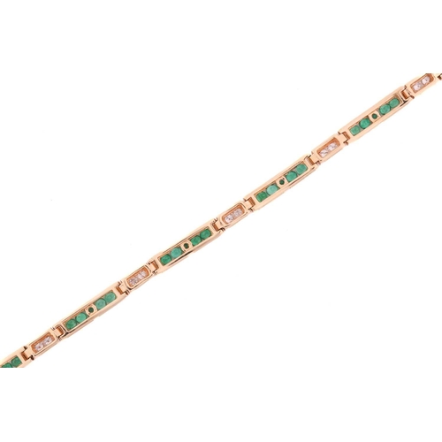 103 - An emerald and diamond line bracelet, comprising slightly curved links channel-set with round emeral... 