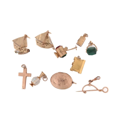 104 - A collection of two brooches, pendants and charms. Consisting of two stone set sailing boat brooches... 