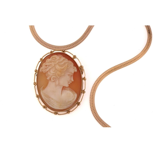 105 - A shell cameo brooch pendant in 9ct gold and a snake chain; the oval shell cameo depicts a side prof... 