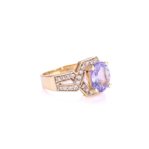 116 - A tanzanite and diamond dress ring, centrally set with oval faceted tanzanite with a light bluish-pu... 