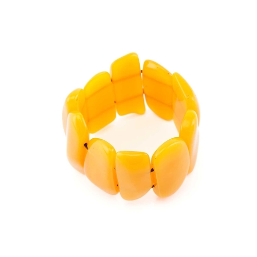 119 - An egg yolk amber panel bracelet; of ten shaped oval and rectangular panels. 100 grams