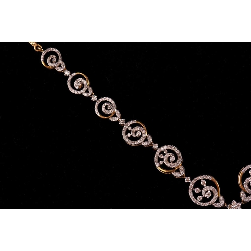 12 - A diamond-set necklace and earrings suite, of swirl designs; the necklace comprises a circular motif... 