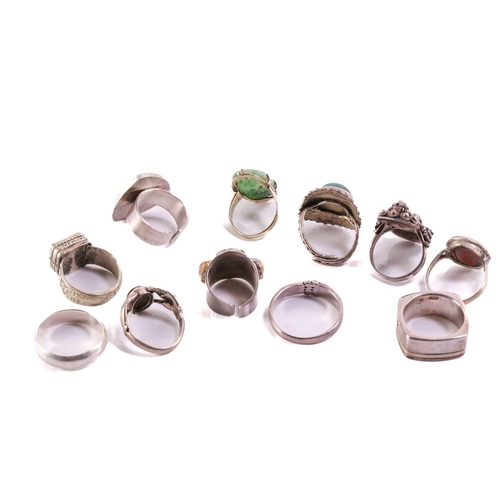 126 - A collection of eleven rings, one yellow metal (tests as 14kt) is set with dyed nephrite, four white... 