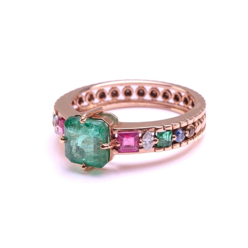 128 - A multi-gem set dress ring, centrally set with a square emerald of 6.2 mm, in claw settings, flanked... 