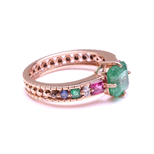 128 - A multi-gem set dress ring, centrally set with a square emerald of 6.2 mm, in claw settings, flanked... 