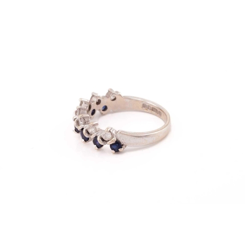 132 - A two-row sapphire and diamond ring in 18ct white gold, comprises seven round sapphires and round di... 