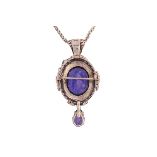 135 - A large tanzanite and diamond brooch pendant on a wheat chain, scintillating with oval fancy-cut tan... 