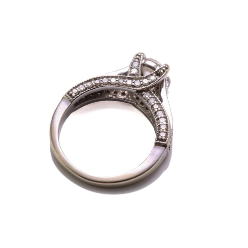 137 - A diamond trellis engagement ring and a fitted enhancer guard; The engagement ring forms from one ce... 