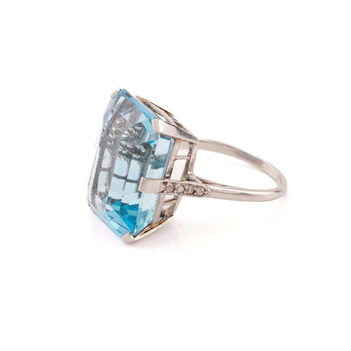 140 - A large aquamarine dress ring, featuring an emerald-cut aquamarine in vivid sky blue colour, approxi... 