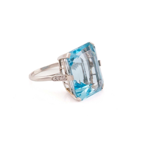 140 - A large aquamarine dress ring, featuring an emerald-cut aquamarine in vivid sky blue colour, approxi... 