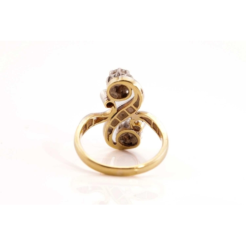 148 - A diamond Toi et Moi ring, of a twisted 'S' form, set with two larger old-European cut diamonds repr... 