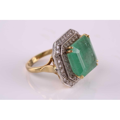 159 - An emerald and diamond cluster ring, featuring a step-cut emerald with a translucent light green-col... 