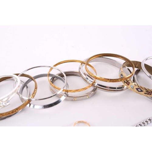 16 - A quantity of assorted base metal costume jewellery including nineteen bangles of various designs, v... 