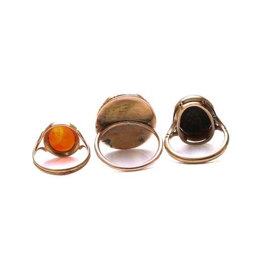 166 - Two cameo rings and an intaglio ring; to include an oval onyx cameo ring, depicting a side profile o... 