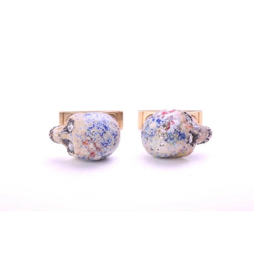 167 - A pair of enamelled skull cufflinks, each comprising a multi-coloured enamelled silver hollow skull,... 