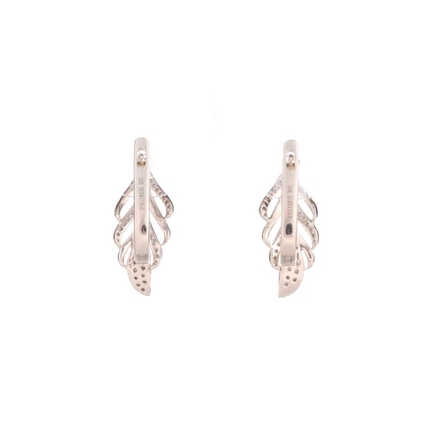 170 - A pair of diamond-set earrings and a conforming pendant; the earrings of feather form, comprise sixt... 