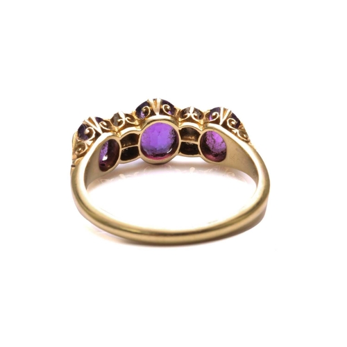 175 - An amethyst and diamond half hoop ring, comprising three graduated oval-shaped amethysts, claw set i... 