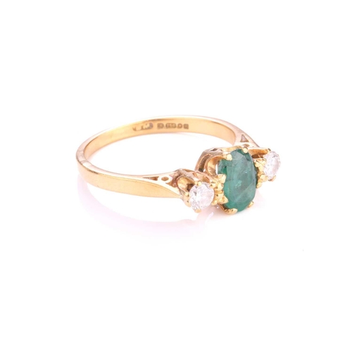 193 - A three-stone emerald and diamond ring, centrally set with an oval-cut emerald with deep green body ... 