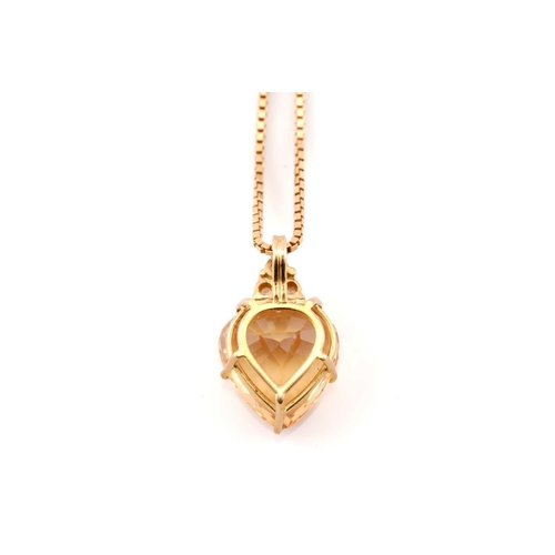 194 - A topaz and diamond pendant on chain, comprises a heart-shaped yellow topaz of 11.3 x 10.6, in a yel... 