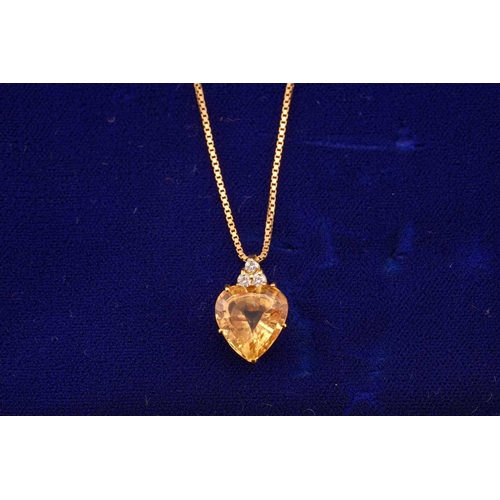 194 - A topaz and diamond pendant on chain, comprises a heart-shaped yellow topaz of 11.3 x 10.6, in a yel... 