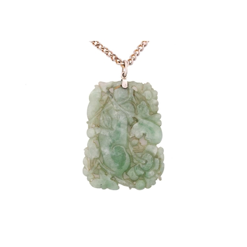 198 - A carved jade pendant, in rectangular form, depicting a stylised ox amidst lotus flowers, attached t... 