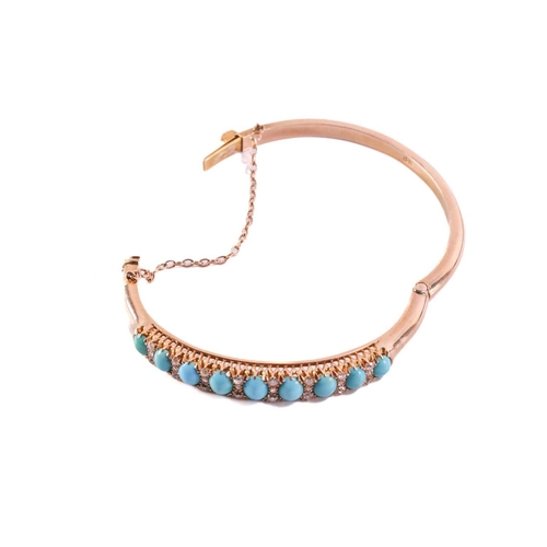 199 - A turquoise and diamond hinged bangle in yellow gold, featuring a graduated row of nine turquoise ca... 