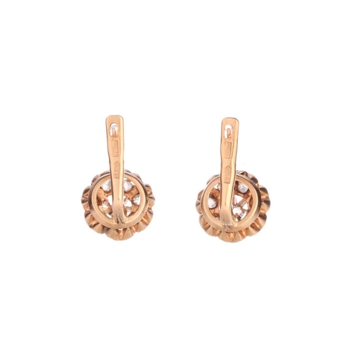 201 - A pair of diamond cluster earrings, each comprising eight rose-cut diamonds in a buttercup setting, ... 