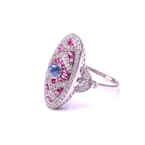 205 - An art deco style oval panel ring set with a Sapphire and Rubies, the central cabochon Sapphire meas... 