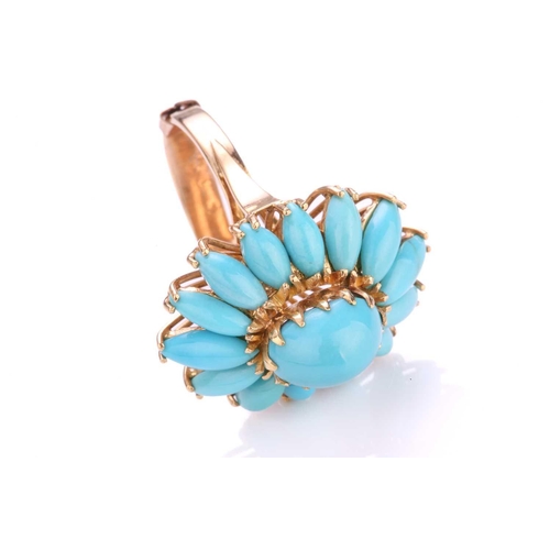 218 - A turquoise flowerhead ring, comprises a high-domed turquoise cabochon claw set in the centre, surro... 