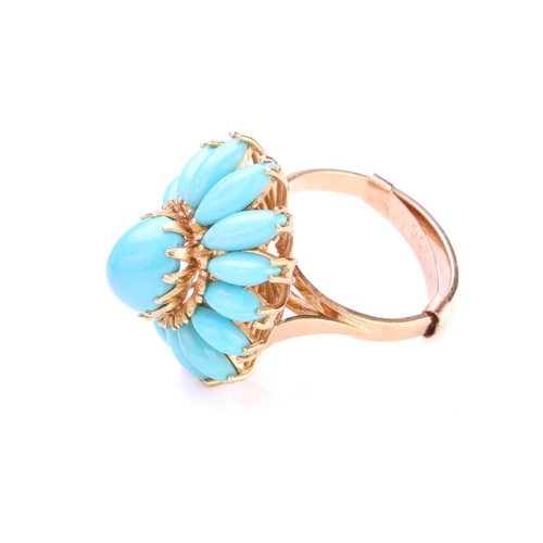 218 - A turquoise flowerhead ring, comprises a high-domed turquoise cabochon claw set in the centre, surro... 