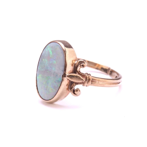 219 - A precious opal dress ring in 9ct gold, featuring an elongated precious opal panel with greyish-blue... 