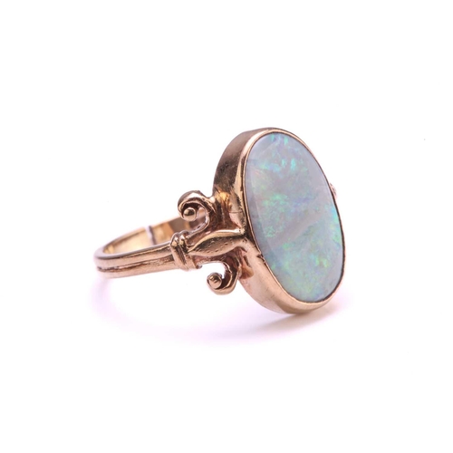 219 - A precious opal dress ring in 9ct gold, featuring an elongated precious opal panel with greyish-blue... 