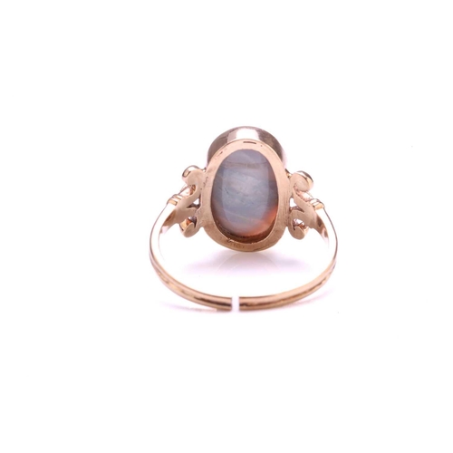 219 - A precious opal dress ring in 9ct gold, featuring an elongated precious opal panel with greyish-blue... 