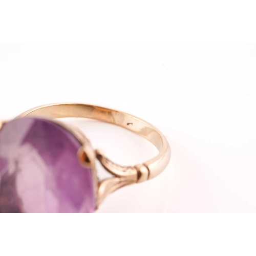 220 - Two gem set dress rings; the first an oval cut amethyst in a mount marked 9ct, size Q; together with... 